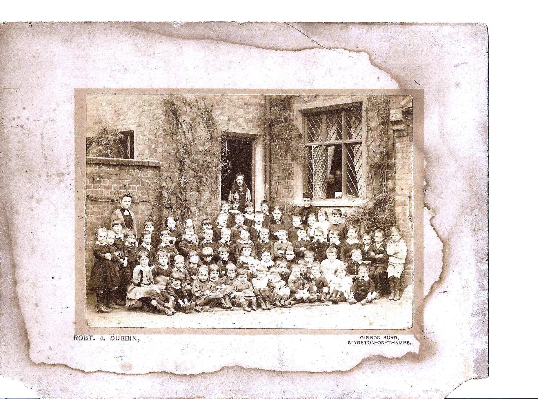 Old School photo of gropups of children in front of school c1900