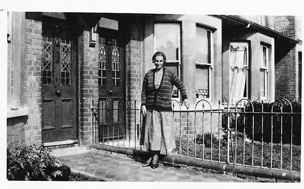 A woman stood outside her house at c1935